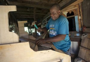 Folk artist Earl Simmons builds a wooden airplane recently at his work space in Warren County. Simmons said he hopes to rebuild after a massive fire destroyed the building in August of 2002.